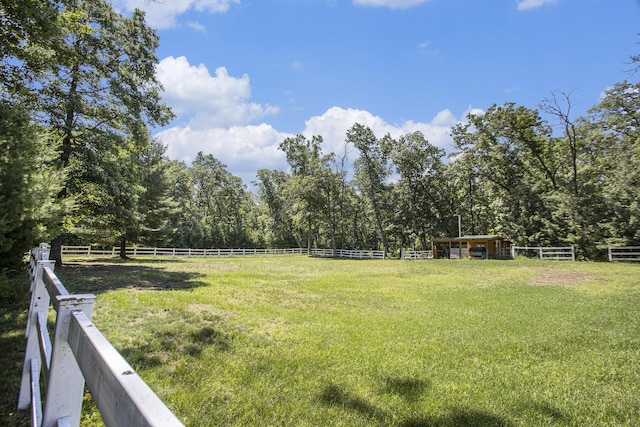 view of yard featuring a rural view and an outdoor structure