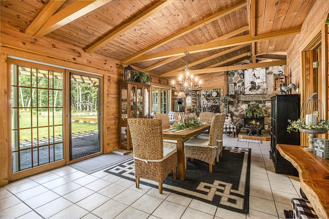 dining space featuring an inviting chandelier, light tile patterned floors, a fireplace, and wooden ceiling