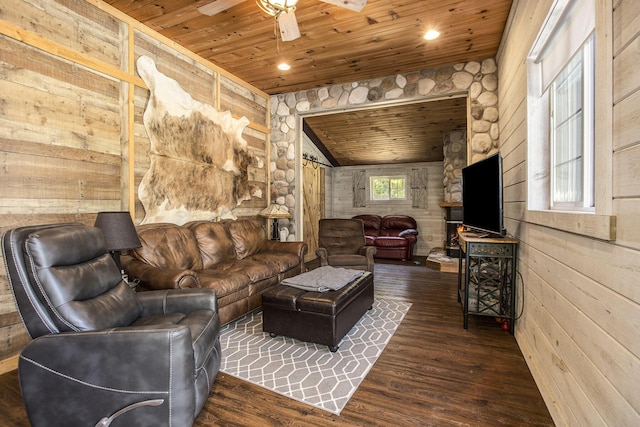 living room featuring ceiling fan, wooden walls, dark hardwood / wood-style floors, and wooden ceiling