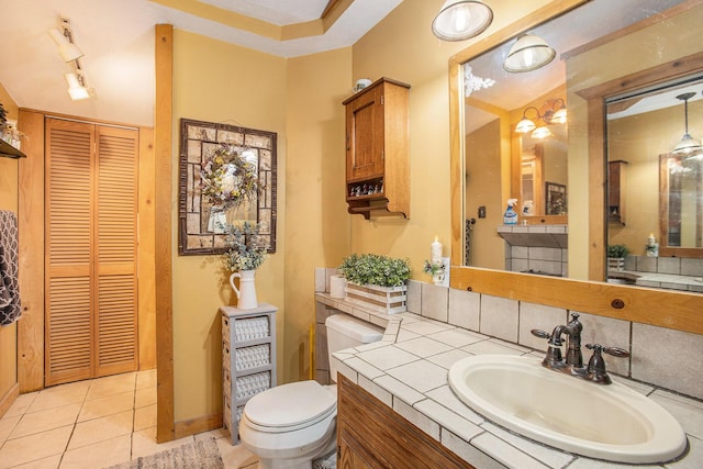 bathroom featuring vanity, tile patterned floors, and toilet