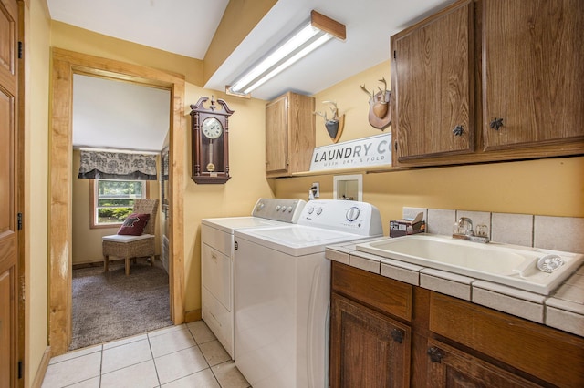 laundry room with cabinets, separate washer and dryer, sink, and light tile patterned floors