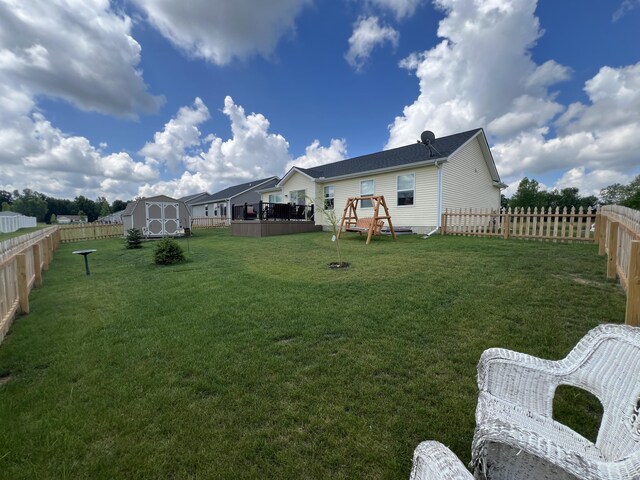 view of yard with a deck and a storage shed