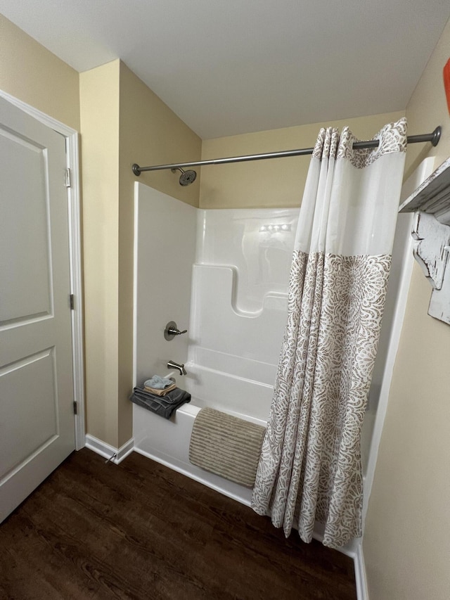 bathroom featuring hardwood / wood-style floors and shower / tub combo