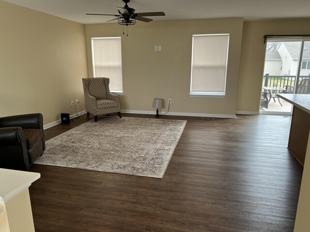 sitting room with dark hardwood / wood-style flooring and ceiling fan