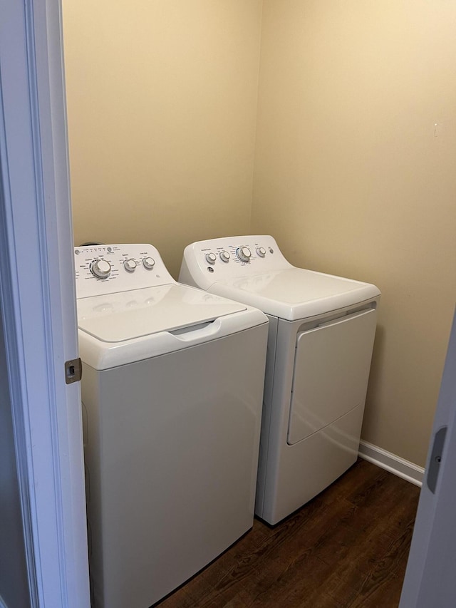 washroom with dark hardwood / wood-style flooring and washer and clothes dryer