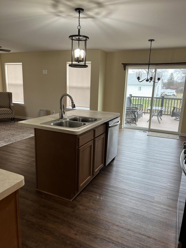 kitchen with dishwasher, sink, hanging light fixtures, and a chandelier