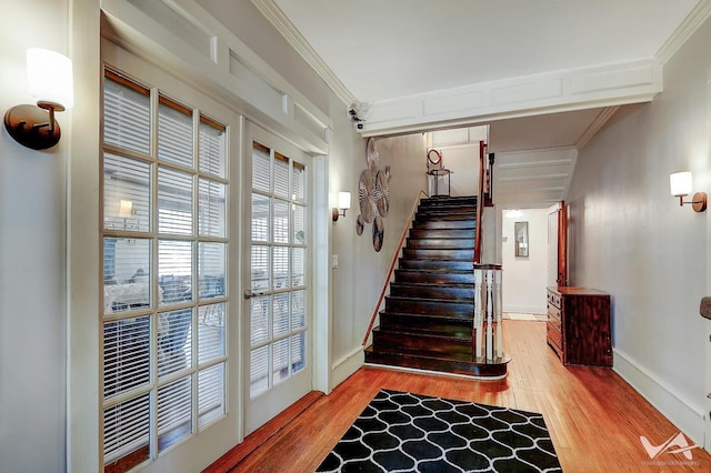 stairway featuring wood-type flooring and ornamental molding