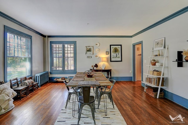 dining space with wood-type flooring, radiator, and crown molding