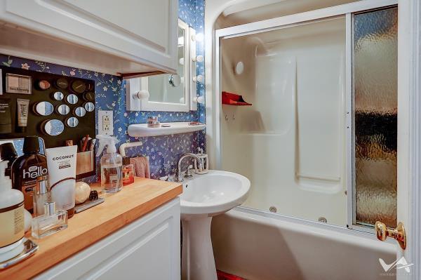 bathroom featuring shower / bath combination with glass door