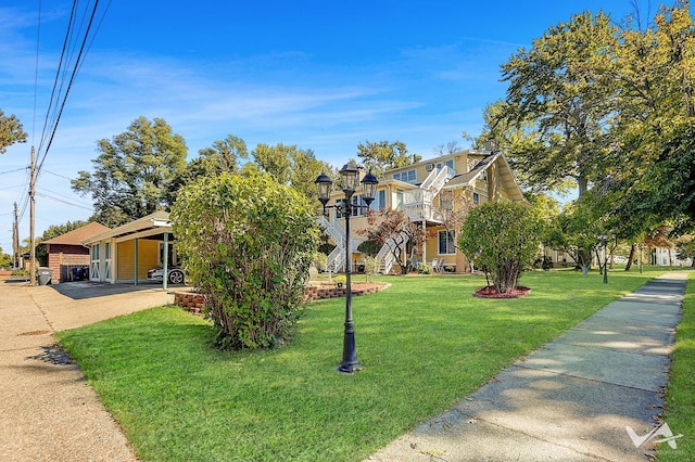 view of front of house with a carport and a front yard