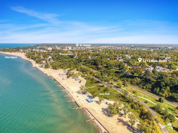 aerial view featuring a water view and a view of the beach