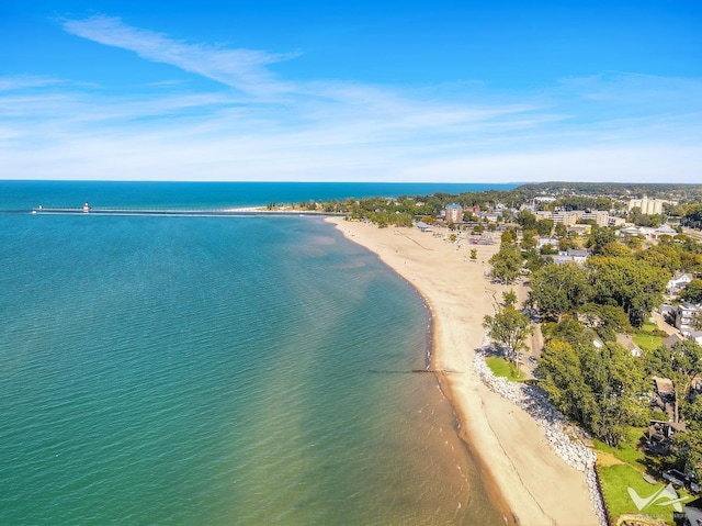 drone / aerial view with a beach view and a water view