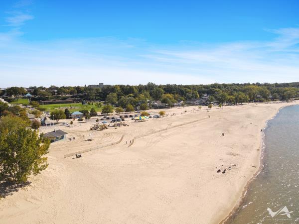 bird's eye view featuring a water view and a beach view