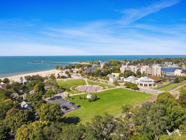 bird's eye view featuring a water view and a beach view