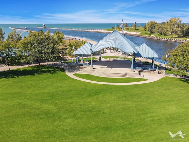 surrounding community with a lawn, a gazebo, and a water view