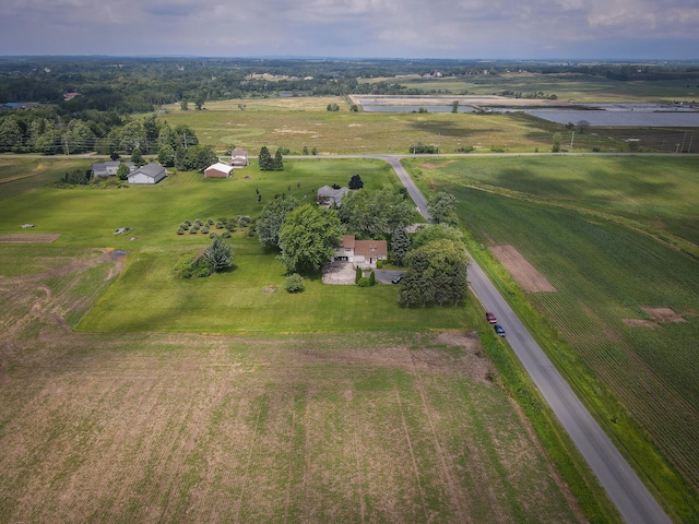 birds eye view of property featuring a water view and a rural view