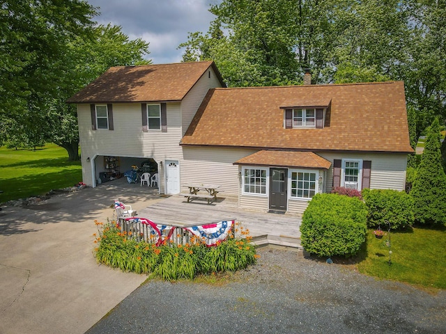 rear view of house featuring a lawn and a wooden deck