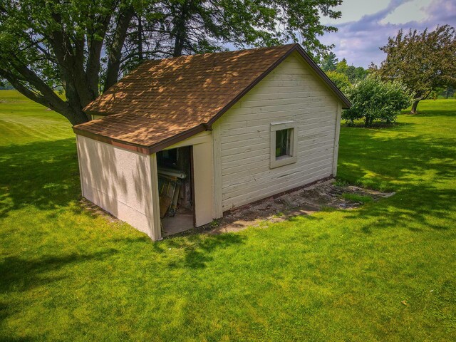 view of outbuilding with a lawn