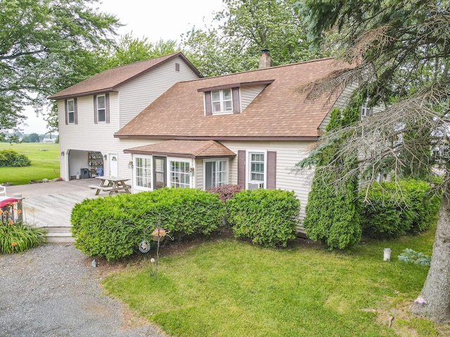 view of front of house featuring a front yard and a wooden deck