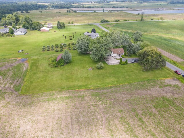 birds eye view of property with a rural view and a water view