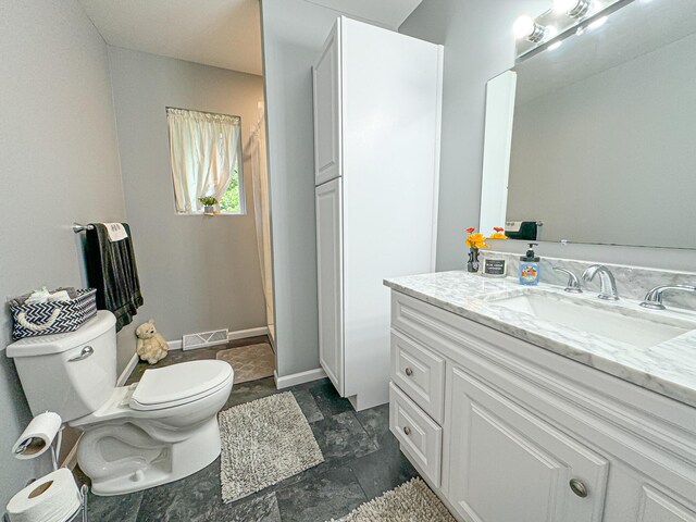 bathroom featuring vanity and toilet