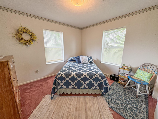 bedroom with a textured ceiling and carpet floors