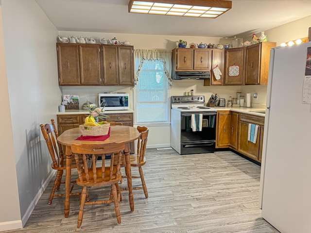 kitchen with white appliances and light wood-type flooring