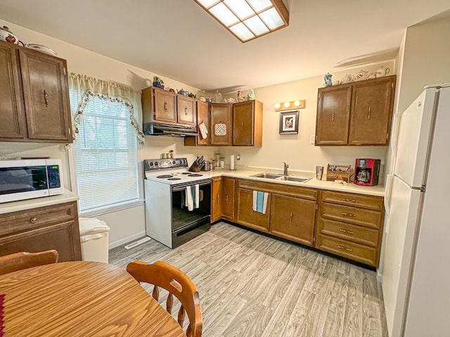 kitchen with sink, electric range, white fridge, and light wood-type flooring