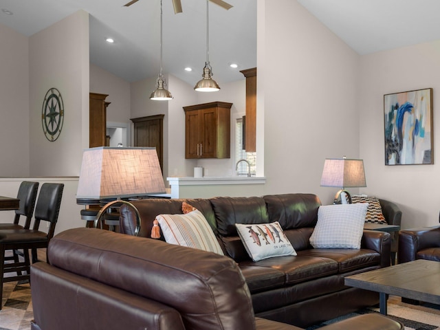 living room featuring ceiling fan and lofted ceiling