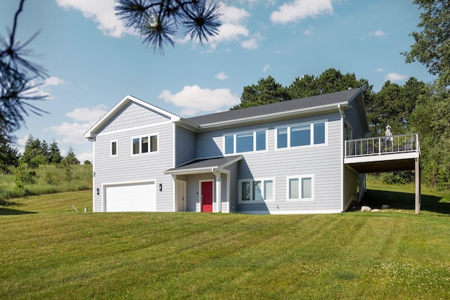 view of front of home featuring a garage, a deck, and a front lawn