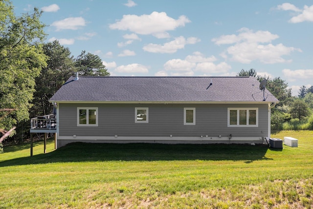 back of house featuring a wooden deck, a yard, and central AC unit