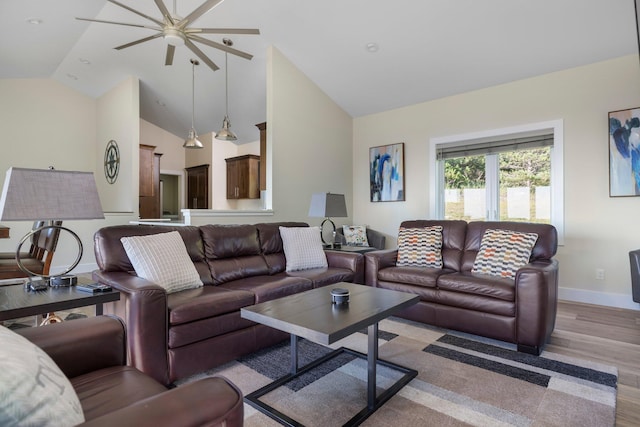 living room featuring vaulted ceiling and light wood-type flooring