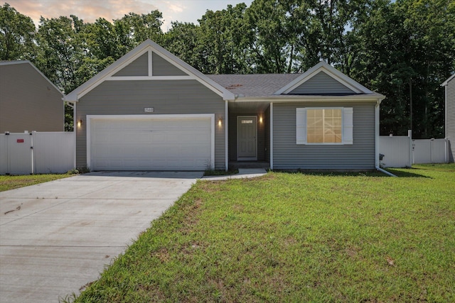 ranch-style house with a garage and a yard