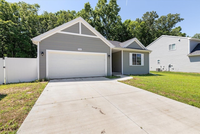 view of front of house with a front yard, a garage, and central AC unit