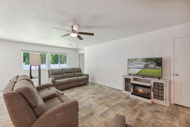 living room featuring ceiling fan and light hardwood / wood-style flooring