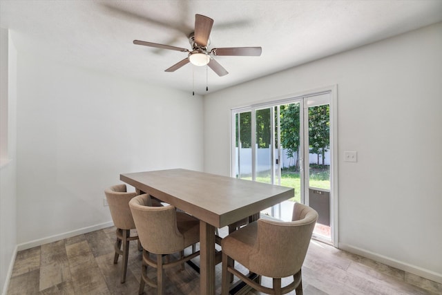 dining space with hardwood / wood-style flooring and ceiling fan