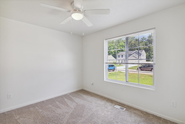 empty room with carpet floors and ceiling fan