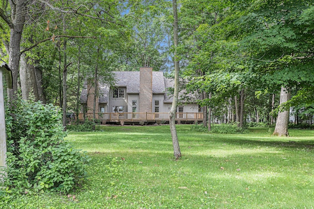 view of front of home featuring a front lawn and a deck