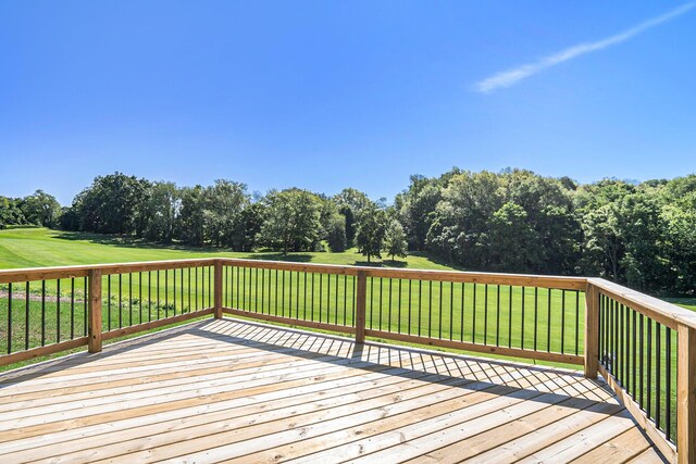 wooden deck featuring a yard