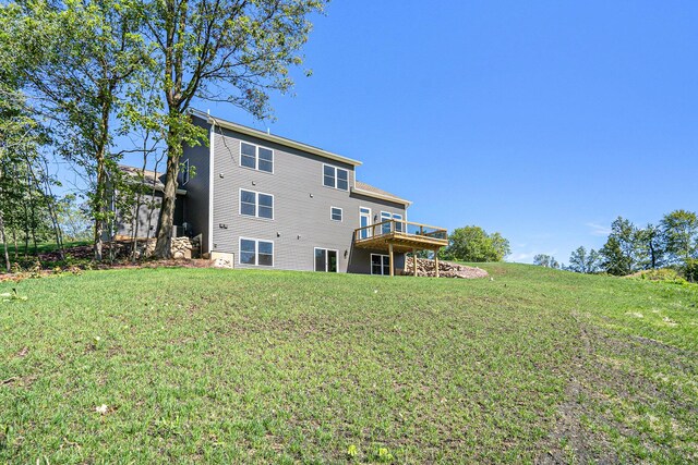 back of house featuring a yard and a wooden deck