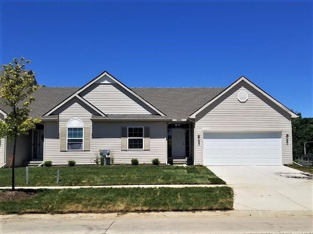 single story home with a garage and a front lawn