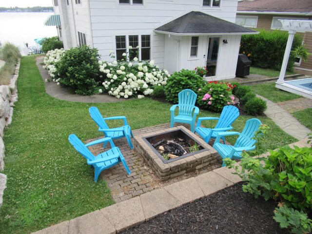 view of patio / terrace featuring a water view and a fire pit