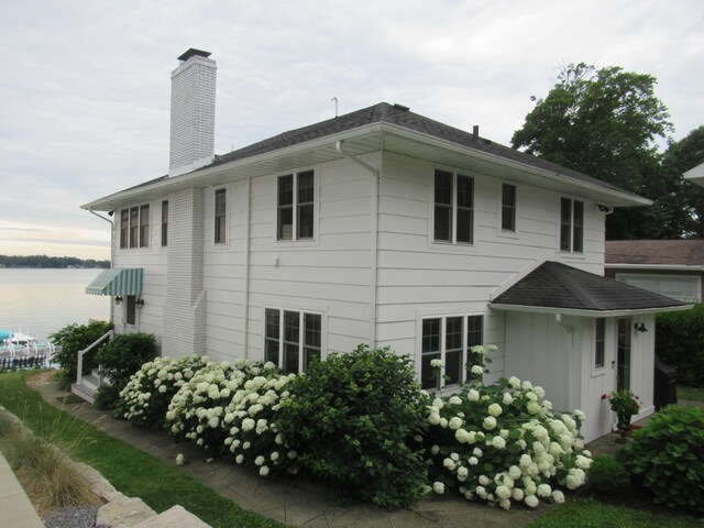 view of side of home featuring a water view