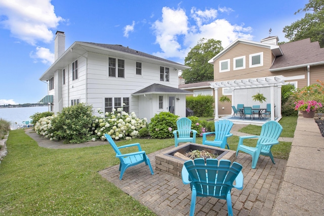 back of property featuring a patio, a fire pit, a yard, a pergola, and a water view