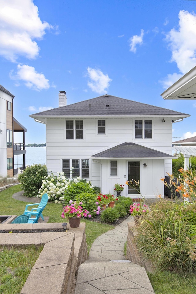 back of house with a water view