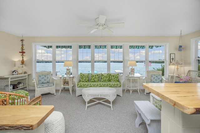 living room featuring a water view, ceiling fan, and carpet floors