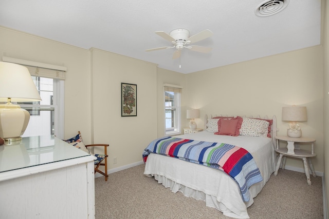 bedroom with light colored carpet and ceiling fan