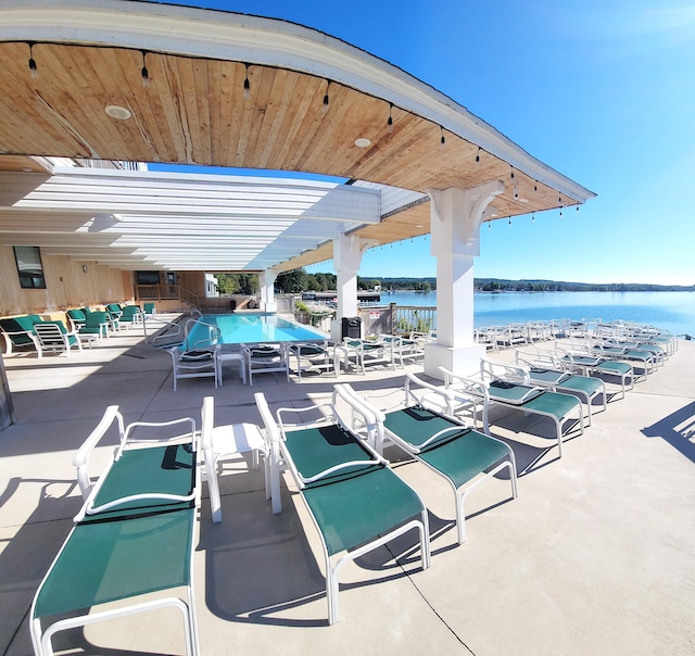 exterior space with a community pool and a water view