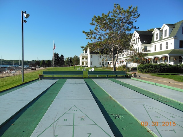 view of property's community with a lawn