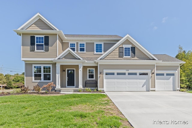 craftsman inspired home featuring a front yard and a garage